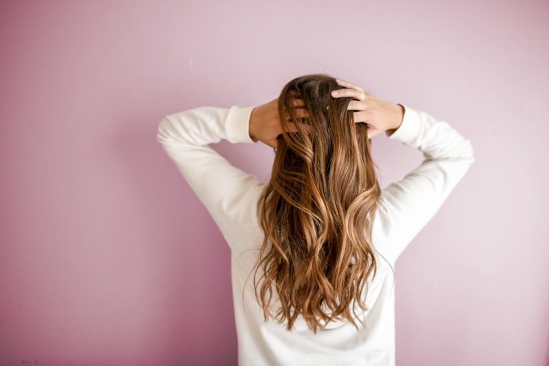 Stylist applying hair colour to a client in the salon